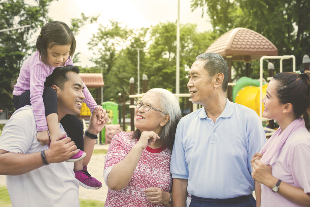 Senior couple with family at the park using senior citizen discount