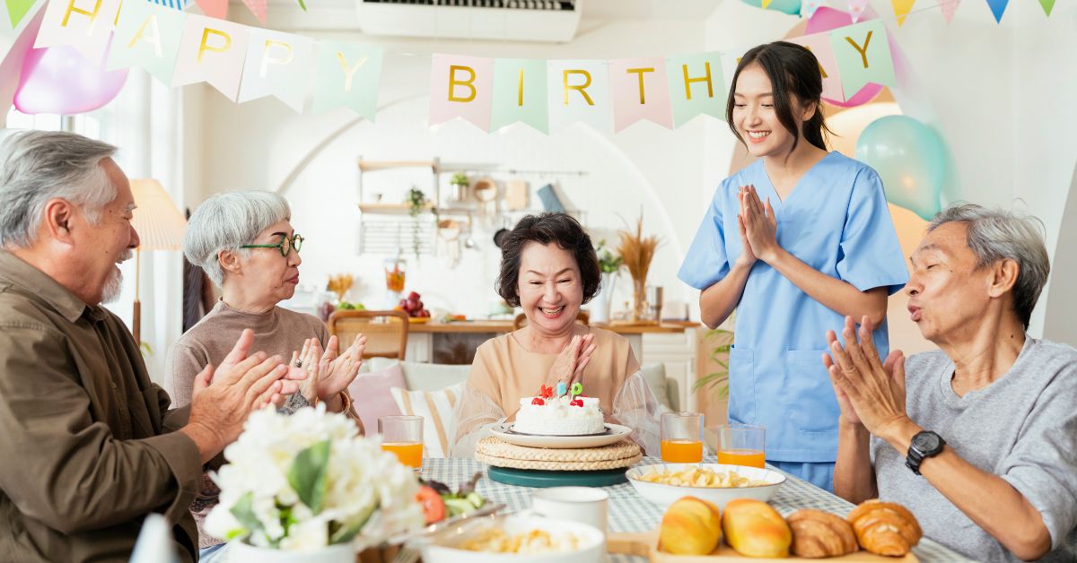 Image of a group of elderly celebrating a birthday together at the senior daycare