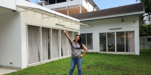 The founder of Oretha's Senior Care, Oretha, standing in front of the second senior daycare at Taman Billion, Cheras.