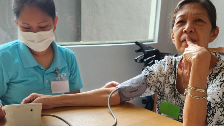 Image of an elderly senior having her blood pressure levels checked daily at Oretha's Senior Daycare