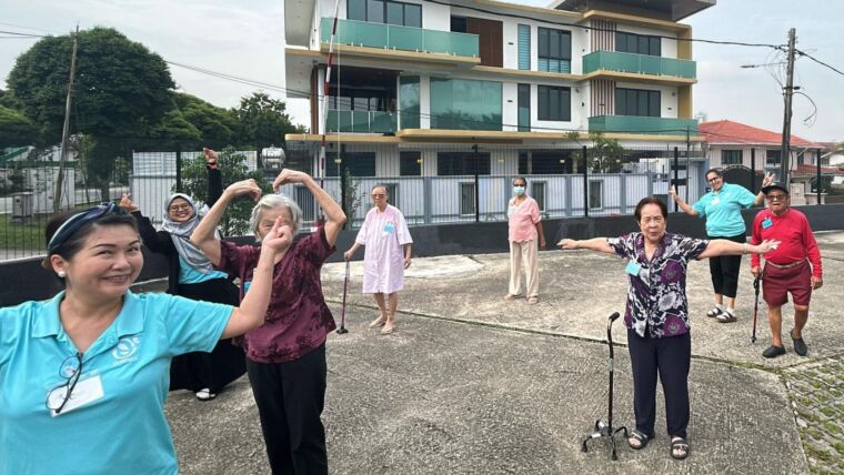 Image of elderly seniors being supervised while having their daily stretch-ups at Oretha's Senior Daycare