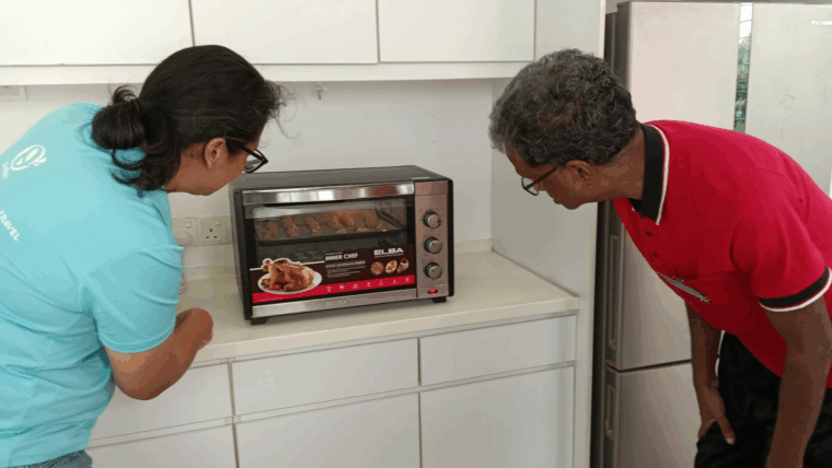 Image of an elderly senior learning to use a microwave at the Oretha's Senior Daycare