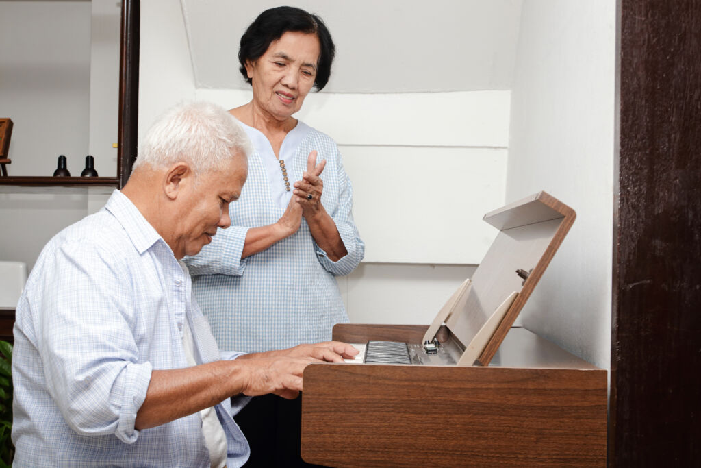Elderly person playing the piano.