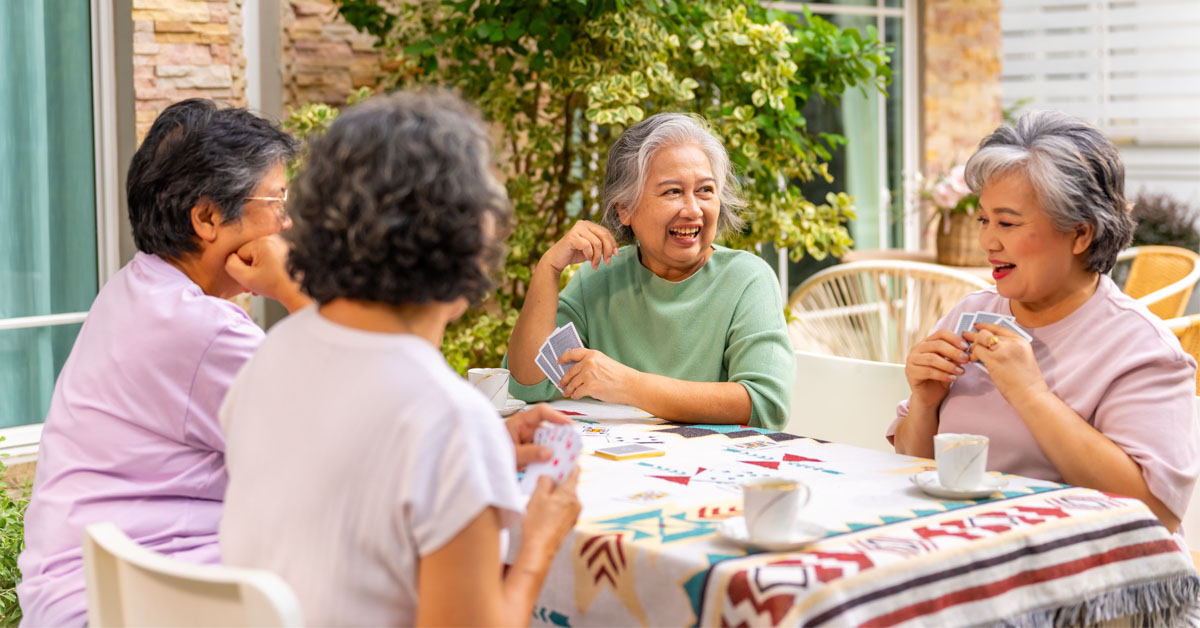Illustration of a group of elderly women playing cards together