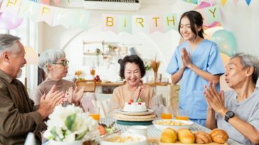 Image of a group of elderly celebrating a birthday together at the senior daycare