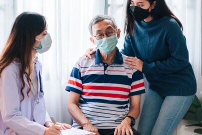 Image of an adult accompanying her elderly parent to consult a doctor. The elderly parent is suspected to be having dementia