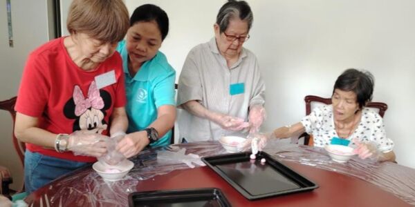 The seniors at the daycare are making 'tang yuen' for Winter Solstice celebration